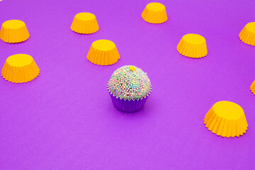 Colorful brigadeiro, Brazilian chocolate truffle dessert, Yellow Packaging Pink background, isolated, focused
