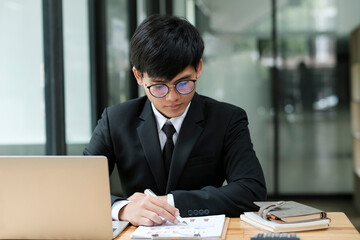 Businessman working at office using laptop.