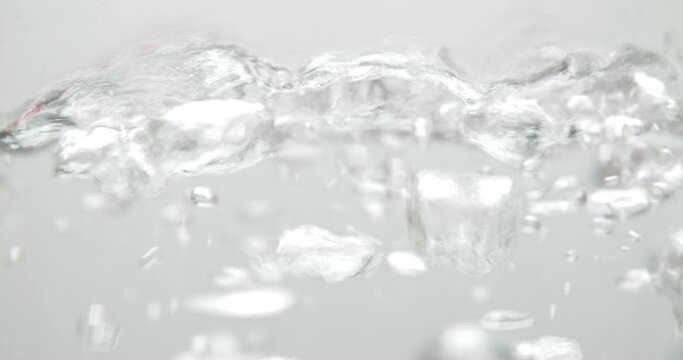 Slow motion of boiling water on a white background.