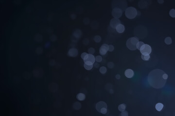 A dark blue background bokeh image for used to decorate background.