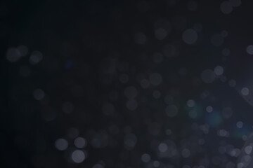 A dark blue background bokeh image for used to decorate background.
