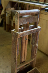 Handmade antique wood board support and guide in a master craftsman carpenter wood shop studio workspace