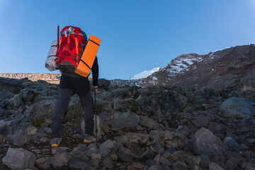 Tourist man hiker on top of the mountain