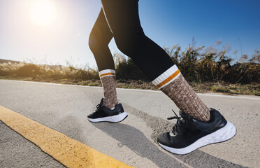 A woman running on a track with lanes