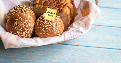 Gluten free label on basket of freshly baked bread and buns. Copy space.