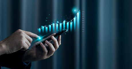 businessman or trader's hand is displaying a growing stock of virtual holograms on smartphones. planning and strategy stock market business growth progress or success concept invest in trading
