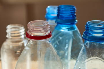Close-up of the neck of several plastic bottles
