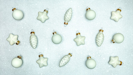various christmas tree decorations and baubles on silver background. above, top view.