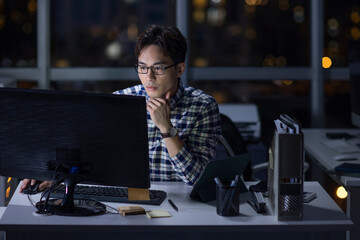 IT worker working in office at night