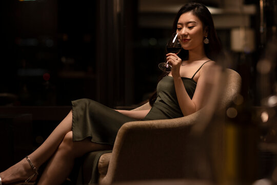 Beautiful young woman drinking red wine