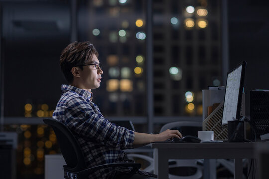 IT worker working in office at night