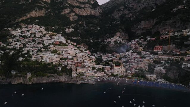 Famous Positano Village Low-Rise Buildings And Houses Nestled On Rocky Hills Of The Amalfi Coast In Salermo Province, Italy. - Drone Tilted Down