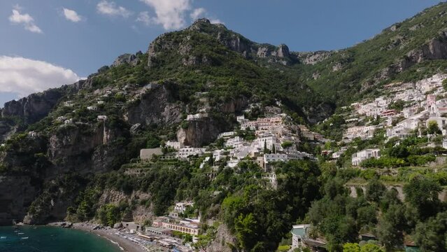 Drone Flying From The Side Of Rocky Amalfi Coast With Lush Greenery Surrounding The Beautiful Village Of Positano In Salermo Province, Italy. - Drone Shot