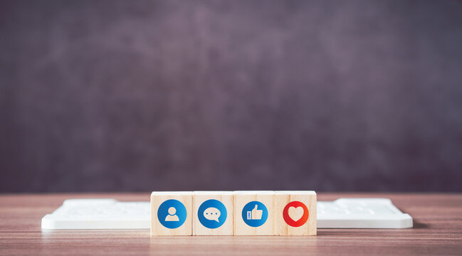 Social media and digital online concept. Wooden cube of icon social media with computer keyboard on table.. - Powered by Adobe