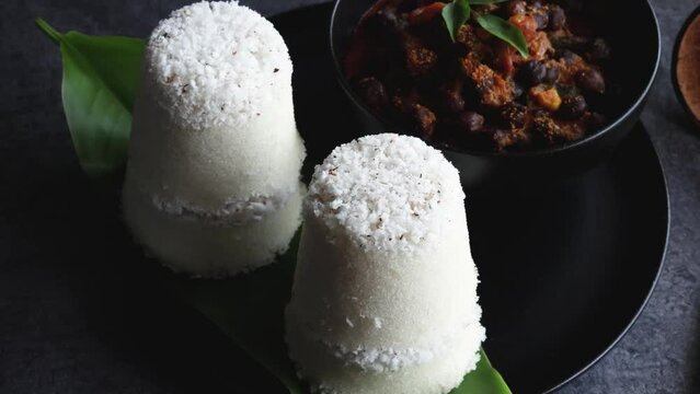 Rice Puttu white Pittu , Kadala Chickpea curry , milk tea , popular South Indian breakfast steamed rice cake Kerala food Tamil Nadu India Sri Lanka. rice flour grated coconut 4k video footage