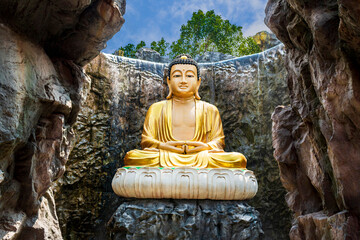 Mahayana buddha statue, Big golden buddha statue in the middle of a beautiful cave.