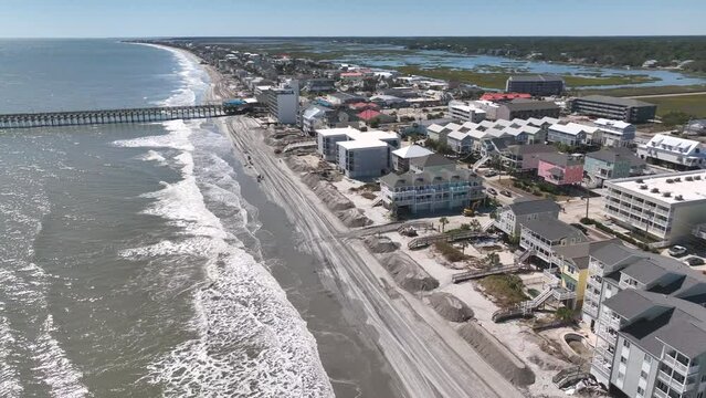 Clean up after Hurricane Ian storm surge causes beach erosion and damages property at Surfside Garden City along coastal South Carolina