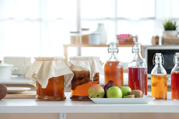 Homemade fermented raw Kombucha tea, healthy natural probiotic flavored drink, variety of Kombucha drink in kitchen