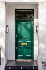 Green front door that is secured.