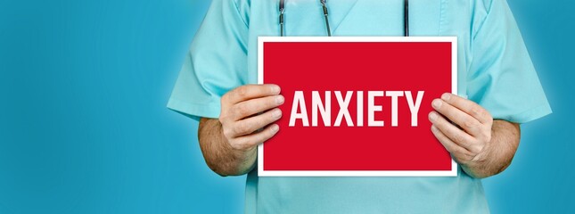 Anxiety. Doctor shows red sign with medical word on it. Blue background.