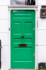 Front green door with mail slot.