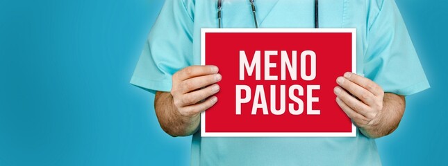 Menopause. Doctor shows red sign with medical word on it. Blue background.