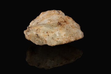The mineral beryl is white in color with a dirty reddish coating on the surface