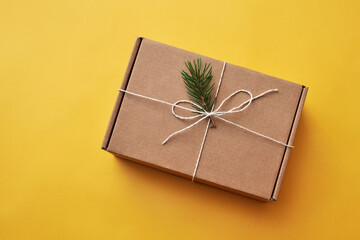 Gift cardboard box with Christmas decor on the table