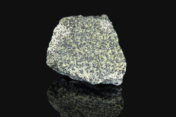 The mineral chromite is gray in color with black inclusions on the surfac