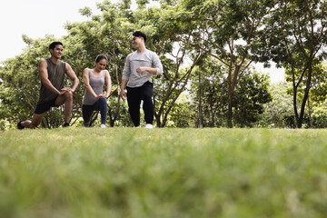 Asian young man and woman stretch body to warm up. Concept for healthy lifestyle and oudoor life.