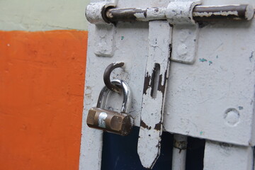 The locked padlock on the iron door is gray. Great for backgrounds