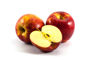Delicious red apples whole and halves piece isolated on white background.