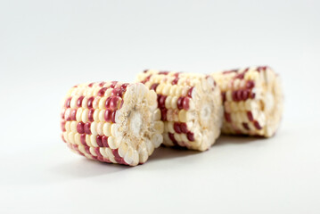 Three halves of waxy corn isolated on white background.