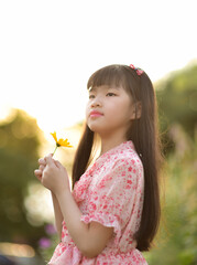  Portrait of a beautiful Asian girl 9 years old with long hair in garden