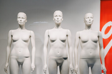 Obraz premium Naked mannequins in the window of a clothing store. Sale and discount concept