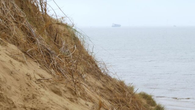 Formby beach, Merseyside coastline beach a ship sails on the horizon