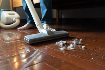 Cleaning dust and hair on the floor with vacuum cleaner