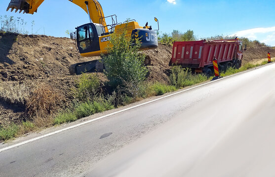 Bucharest, Romania - September 12, 2022: Loading gravel JSB on the construction of a protective dam