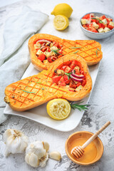 Halved roasted butternut squash with spicy vegetable filling and feta cheese