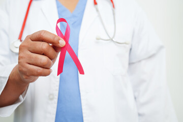 Asian woman doctor with pink ribbon, World Breast Cancer Day at October.