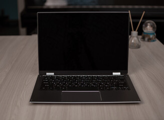 A working table against the background of a closed piano in the house.
Focus in the center.