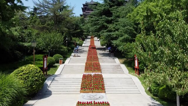 Aerial slow ascending view of Huancui lou pagoda from the stairs in Weihai, China.