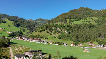 Fototapeta na wymiar Alpen landscape with green meadows and mountains