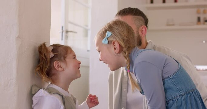 Children check height growth with father on the wall in the house for healthy development progress as young girls or kids. Smile, family and happy school students mark growing measurement at home