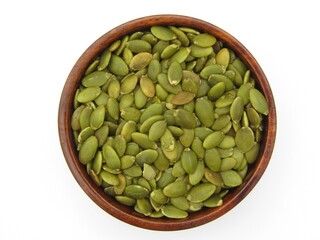 Pumpkin seeds in a wooden bowl on white background 