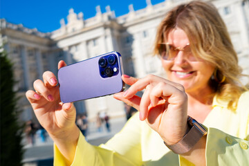 Woman taking photo with mobile phone