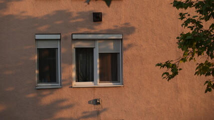 Window of on the pink wall of a community house