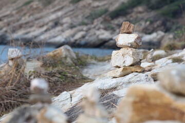 Rock balance. Stones placed one on top of the other, on the beach. The sea in the background