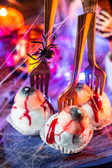 Halloween sweet food on decorated table. Blurred background. Kids spooky party