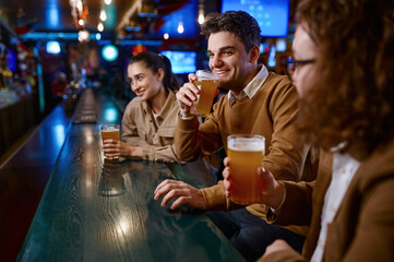 Group of happy friends resting and talking at bar